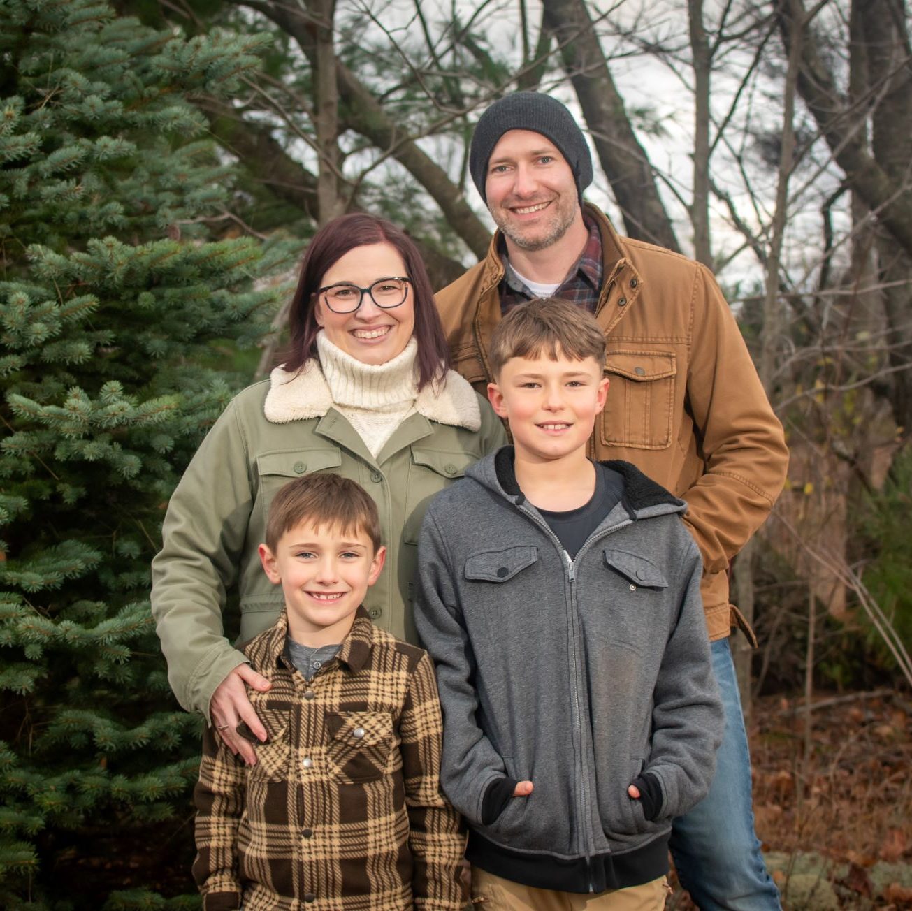 Michaela bring detailed work ethic and experience to her work. She stands in a family photo with her husband, Chris, and their two sons.